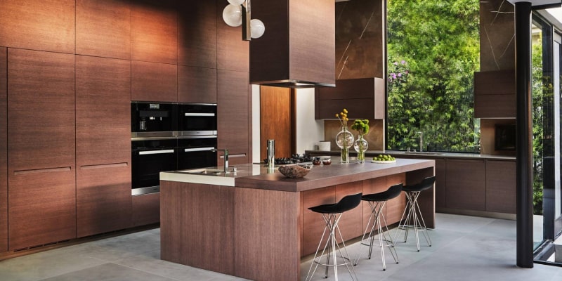 Modern Dubai kitchen with dark wood cabinets and island – Dubai kitchen cabinet materials